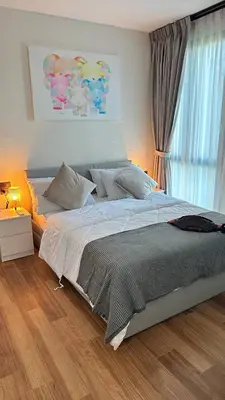 a bedroom with a large bed and a window at Phuket apartment in Nai Yang Beach