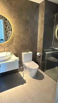 a bathroom with a toilet and a sink and a mirror at Phuket apartment in Nai Yang Beach
