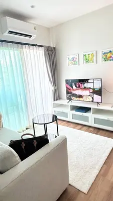 a living room with a couch and a flat screen tv at Phuket apartment in Nai Yang Beach