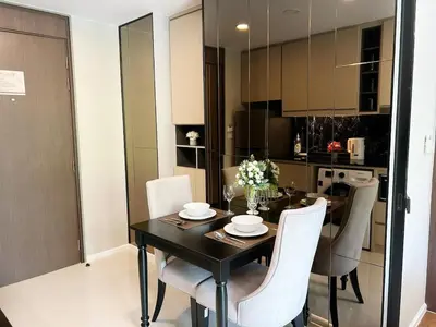 a dining room table and chairs in a kitchen at Seaview, 1 bd, Surin beach in Surin Beach