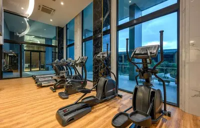a gym with treadmills and elliptical machines at Seaview, 1 bd, Surin beach in Surin Beach