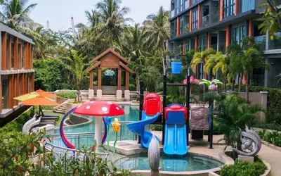 a pool with a water slide in a resort at Seaview, 1 bd, Surin beach in Surin Beach