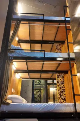 three bunk beds in a room with a mirror at Hangover #1 Hostel Patong in Patong Beach