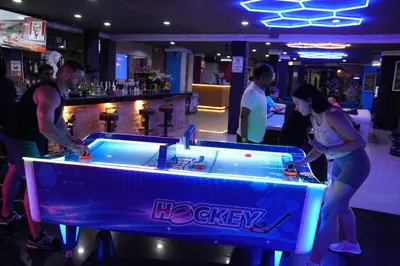 a group of people playing pool in a bar at Hangover #1 Hostel Patong in Patong Beach
