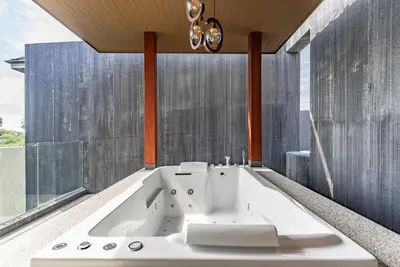 a white bath tub in a bathroom with a window at Chariot by Villacarte in Layan Beach