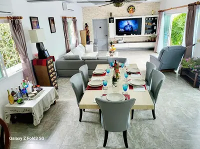 a living room with a long table and chairs at Villa 320m2 Piscine privée 4 chambres à Kamala in Kamala Beach