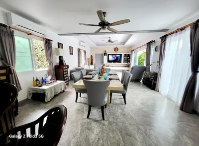 a living room with a table and chairs and a couch at Villa 320m2 Piscine privée 4 chambres à Kamala in Kamala Beach