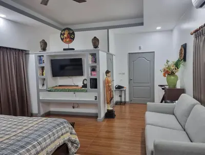 a living room with a tv and a couch at Villa 320m2 Piscine privée 4 chambres à Kamala in Kamala Beach