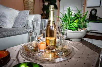 a bottle of champagne and wine glasses on a table at Villa 320m2 Piscine privée 4 chambres à Kamala in Kamala Beach