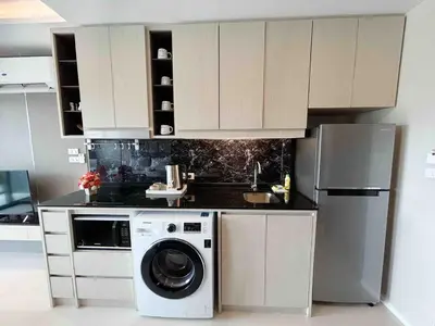 a kitchen with a washing machine and a refrigerator at Seaview, cozy apartment, Surin in Surin Beach
