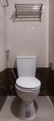 a bathroom with a white toilet in a room at Lovely Mai Khao studio room in Mai Khao Beach