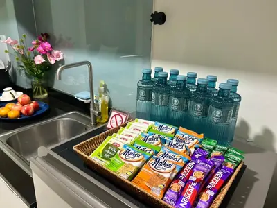 a counter with a tray of chips and bottled water at Serene Panwa beachfront in Ban Ao Makham