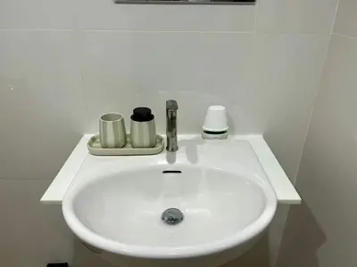 a white sink with two cups on it at Serene Panwa beachfront in Ban Ao Makham