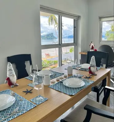 a dining room table with a view of the ocean at Villa Miyoko Ko Yao Noi Enjoy nature's beauty and stunning sunsets in Ko Yao Noi