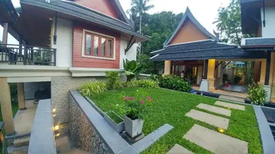a house with a garden in front of it at Salika Luxury 5.5 Bed Villa Seaview With Maids in Rawai Beach