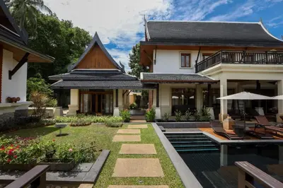 a house with a garden and a patio at Salika Luxury 5.5 Bed Villa Seaview With Maids in Rawai Beach