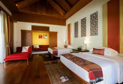 a bedroom with two beds and a red chair at Salika Luxury 5.5 Bed Villa Seaview With Maids in Rawai Beach