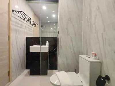 a white bathroom with a toilet and a sink at Brand New 2 Bed Seaview Apartment Utopia Karon in Karon Beach