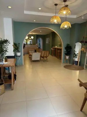 a restaurant with an archway and tables and chairs at Eco Phuket old town in Ban Lo Long