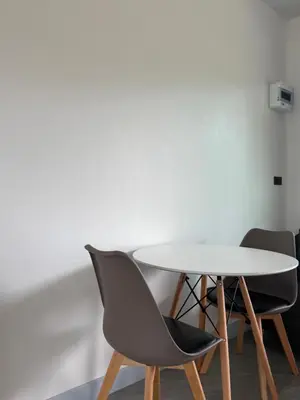 a table and two chairs in a room at P One Apartments in Phuket Town