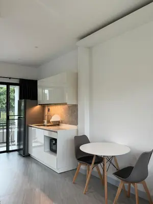 a kitchen with a table and two chairs at P One Apartments in Phuket Town