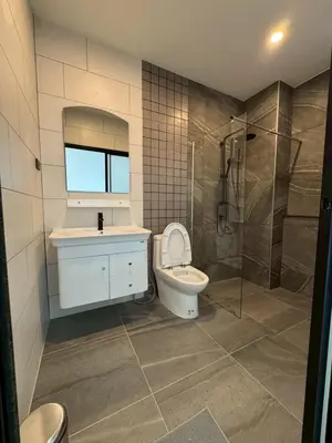 a bathroom with a toilet and a sink and a shower at P One Apartments in Phuket Town