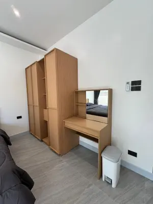 a bedroom with a desk and a mirror at P One Apartments in Phuket Town