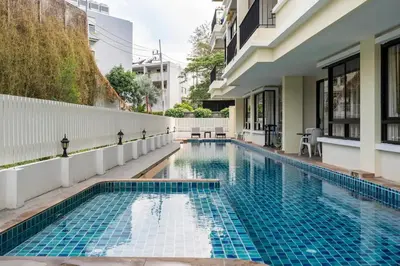 a swimming pool in the middle of a building at The Lago by Villacarte in Rawai Beach