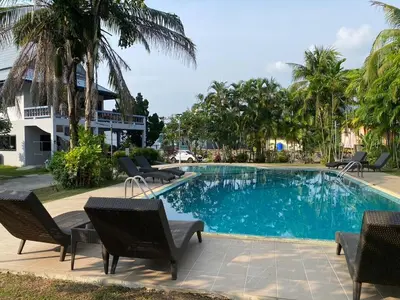 a swimming pool with chairs and a resort at Cozy Space Kamala in Kamala Beach