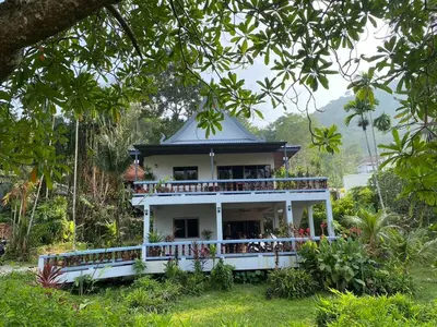 a house in the middle of a garden at Cozy Space Kamala in Kamala Beach