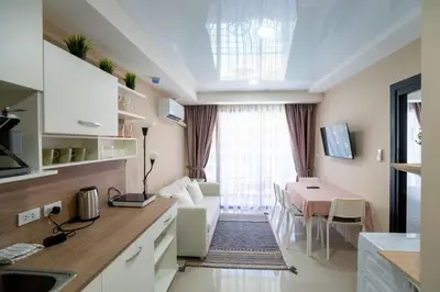 a kitchen and living room with a dining room at The Urban Tropical Apartments in Mai Khao Beach
