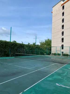 a tennis court in front of a building at СС619 Романтика, чудесный вид и домашний уют in Mai Khao Beach