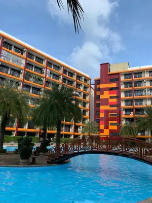 a bridge over a swimming pool in front of a building at СС619 Романтика, чудесный вид и домашний уют in Mai Khao Beach