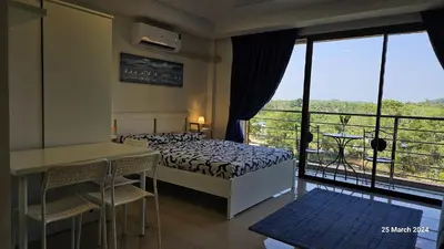 a bedroom with a bed and a balcony with a view at СС619 Романтика, чудесный вид и домашний уют in Mai Khao Beach