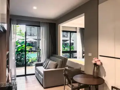 a living room with a couch and a table at Cozy apartment Banggtao beach in Bang Tao Beach