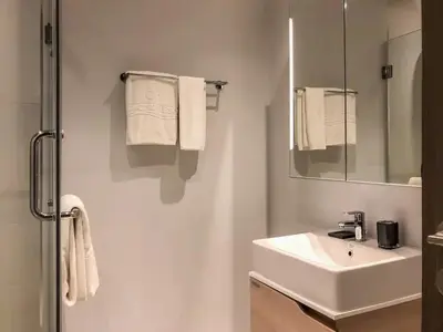 a white bathroom with a sink and a mirror at Cozy apartment Banggtao beach in Bang Tao Beach