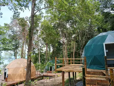 a tent and a wooden table with a wooden table at NATUR - Krabi Campsite Glamping & Camping in Krabi town