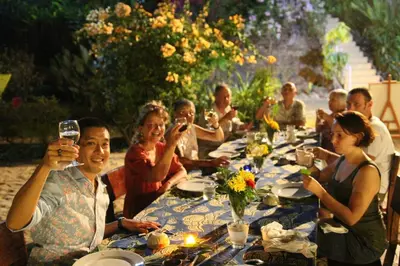 a group of people sitting at a table with wine glasses at NATUR - Krabi Campsite Glamping & Camping in Krabi town