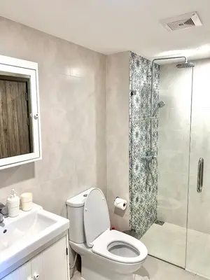 a bathroom with a toilet and a shower and a sink at Condo of Light Swimming Pool in Ban Bo Han