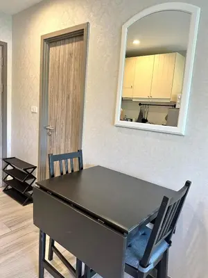 a black table with two chairs and a mirror at Condo of Light Swimming Pool in Ban Bo Han