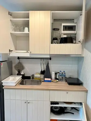 a kitchen with a sink and a microwave at Condo of Light Swimming Pool in Ban Bo Han