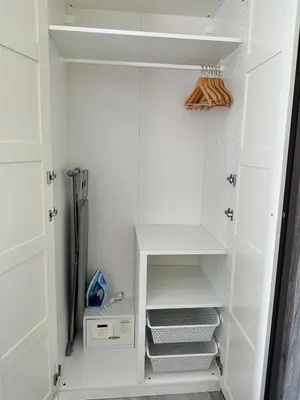 a closet with white walls and white shelves at Condo of Light Swimming Pool in Ban Bo Han