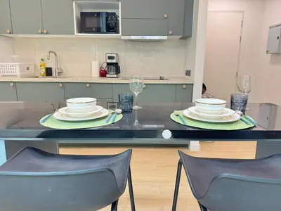 a kitchen with a table with plates on it at Tropical Living Kamala Hillside in Kamala Beach