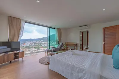 a bedroom with a white bed and a large window at Luxury Seaview Villa in Patong - Villa Yona in Patong Beach