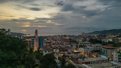 a cityscape of a city at sunset at Luxury Seaview Villa in Patong - Villa Yona in Patong Beach