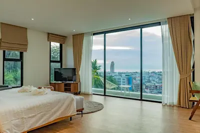 a bedroom with a bed and large glass windows at Luxury Seaview Villa in Patong - Villa Yona in Patong Beach