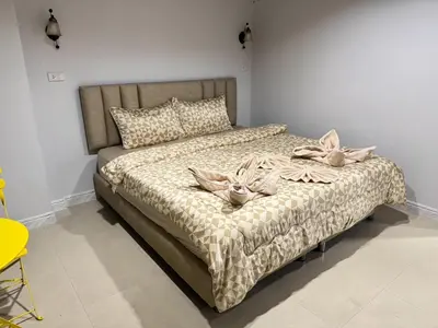 a bedroom with a bed with pillows on it at Miley Guesthouse in Phi Phi Don
