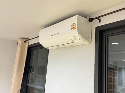a air conditioner is attached to a wall next to a window at Miley Guesthouse in Phi Phi Don