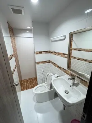 a bathroom with a sink and a toilet and a mirror at Miley Guesthouse in Phi Phi Don