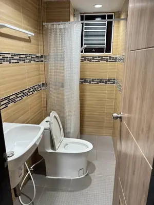 a bathroom with a toilet and a sink at Miley Guesthouse in Phi Phi Don